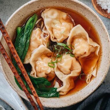 Bowl of shrimp wonton soup with wontons in clear broth