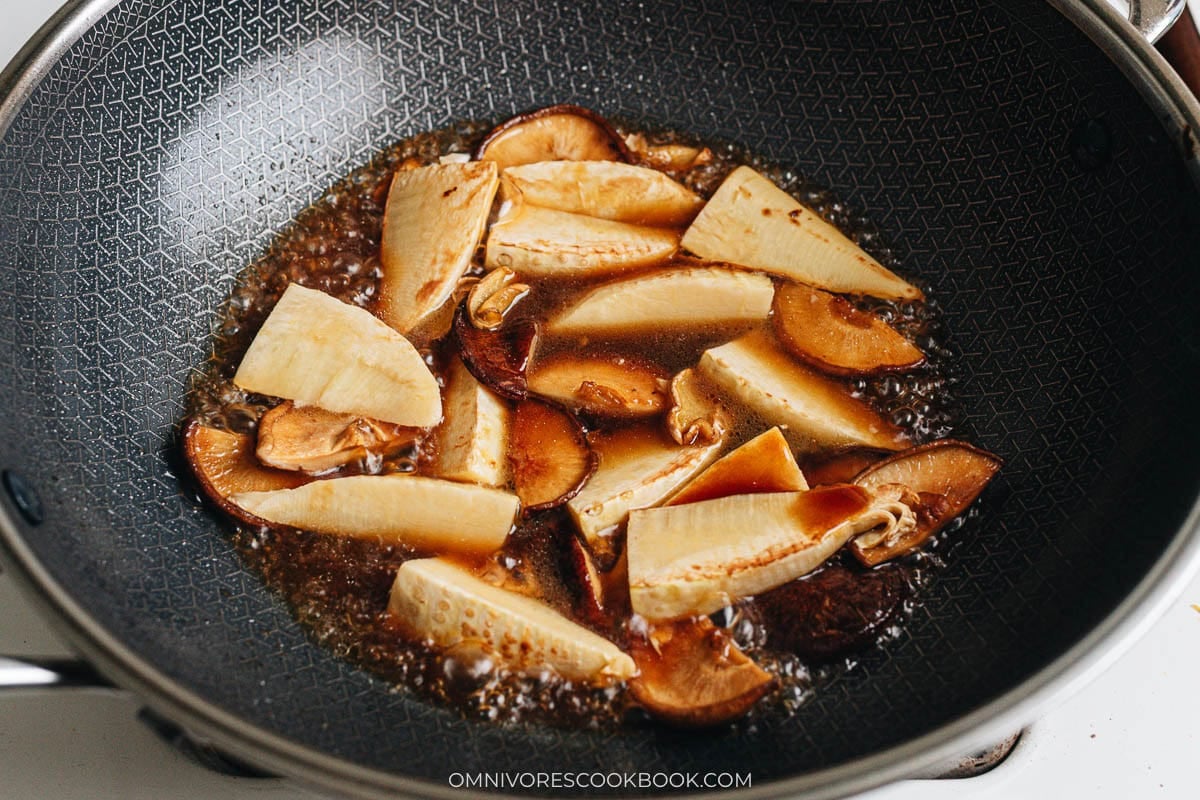 Bamboo shoots and shiitake mushrooms braising in soy based sauce
