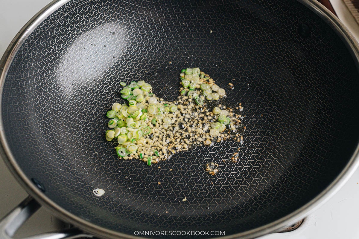 Ginger and scallion sizzling in oil in a wok