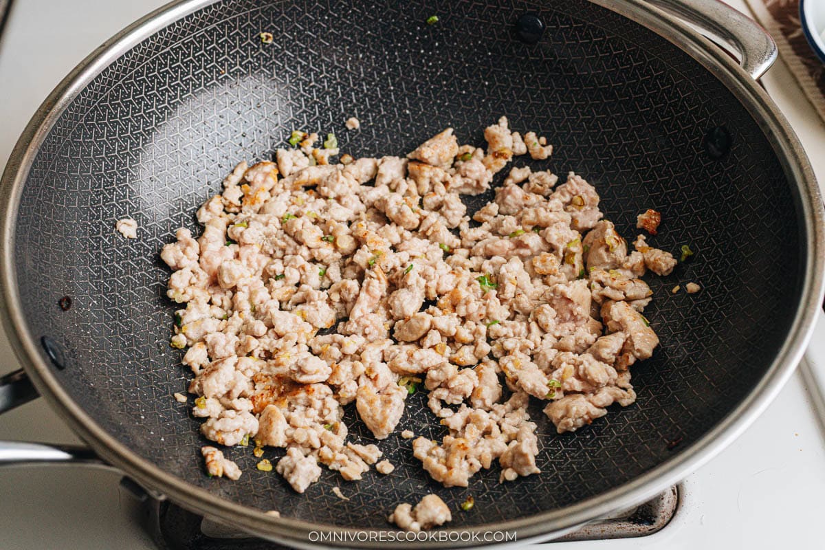 Ground chicken browning in a wok