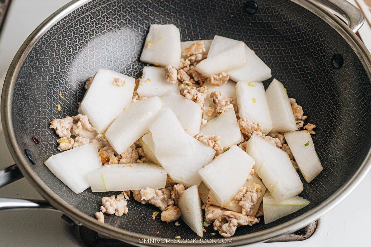 Adding winter melon chunks to the wok