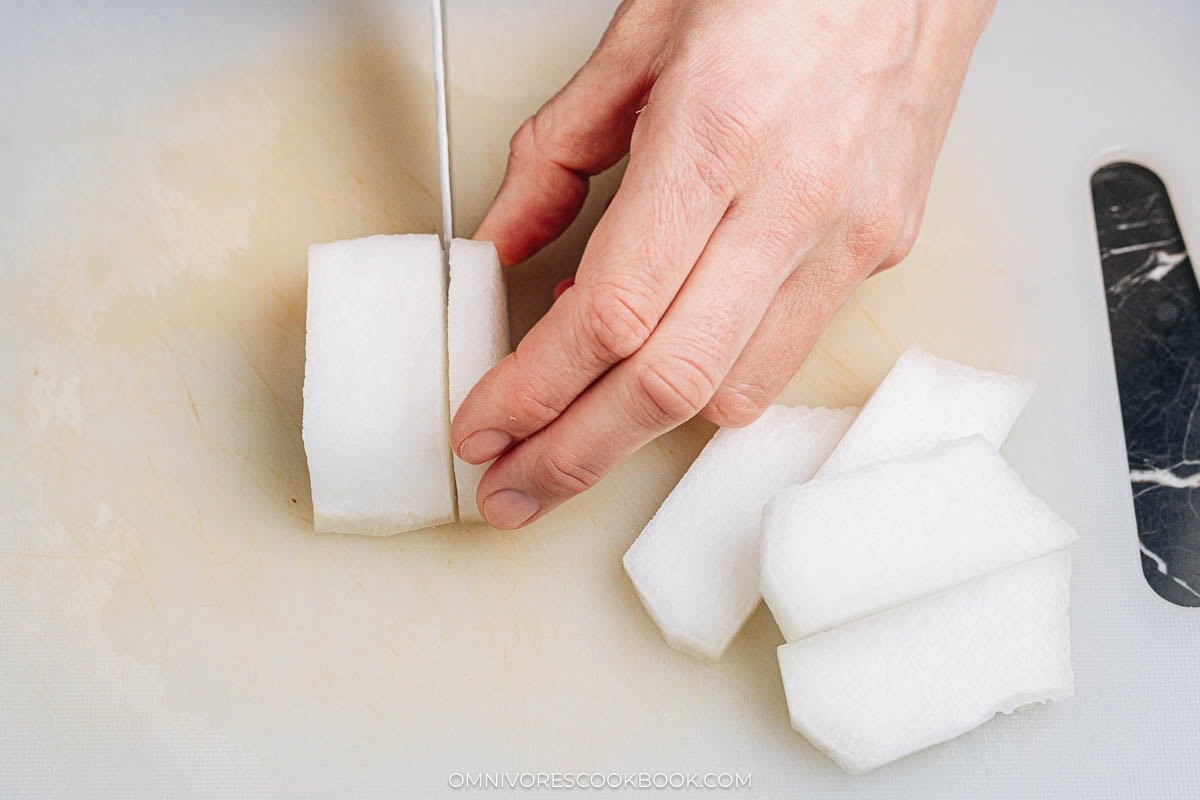 Cutting winter melon into chunky cubes