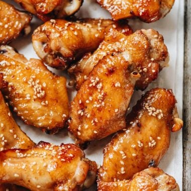 Baked Chimese honey soy chicken wings on parchment lined baking sheet