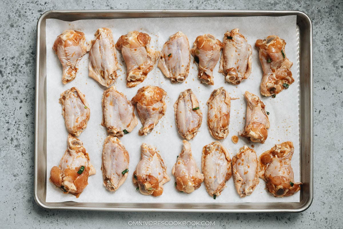 chicken wings layered on a sheet pan