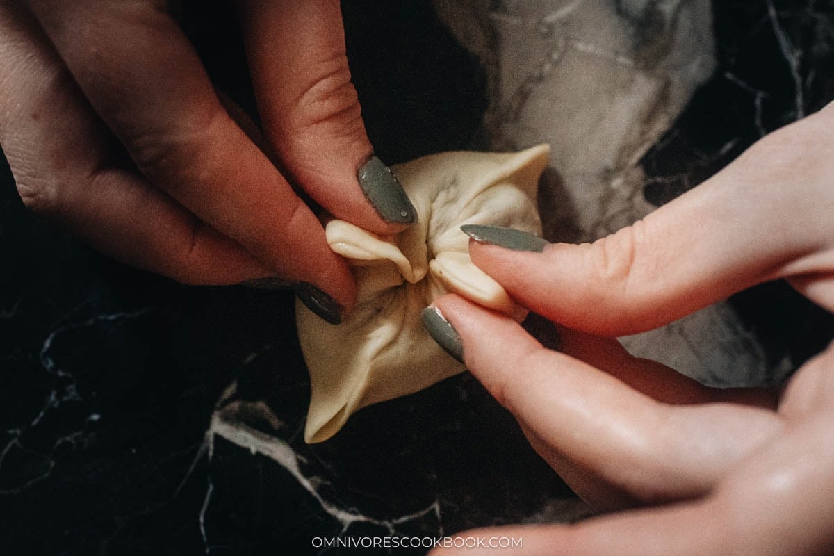 Pinch the rest of the edges to seal the bun
