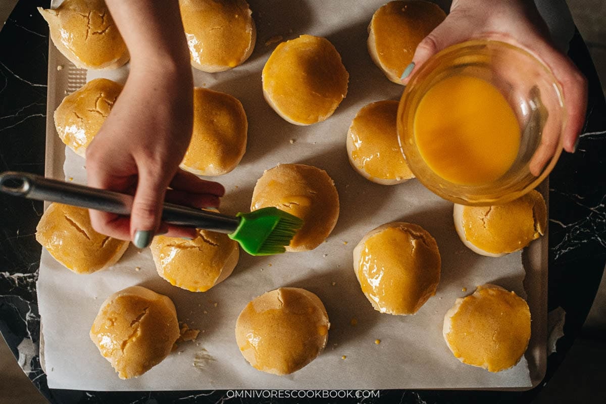 brushing buns with egg mixture