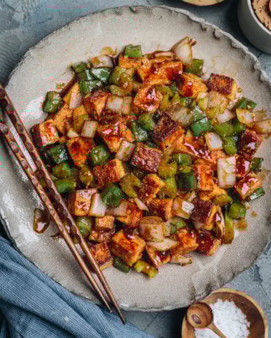 Close-up of crispy stir-fried tofu, green pepper, celery, and onion