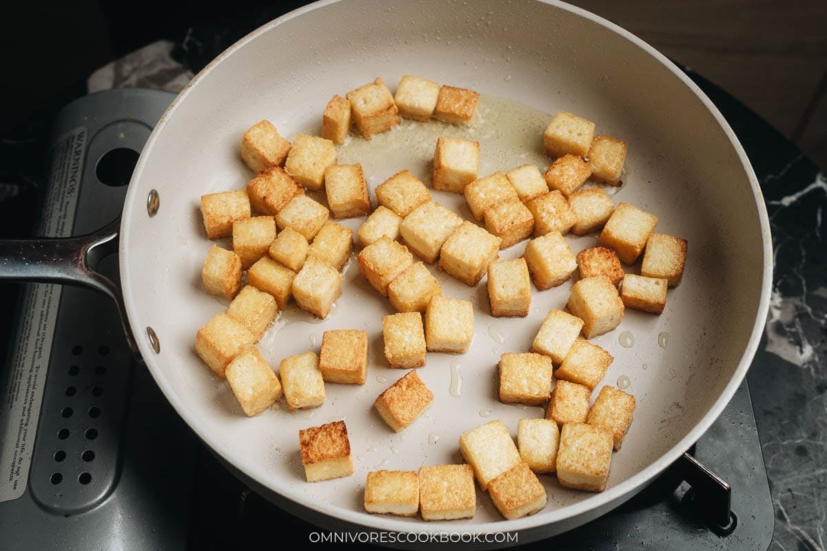 cooking the tofu bits in a pan