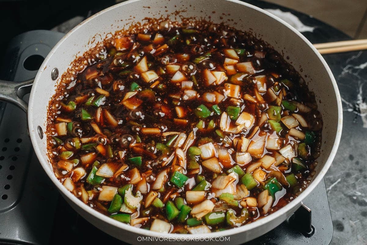 combining tofu and sauce in a pan