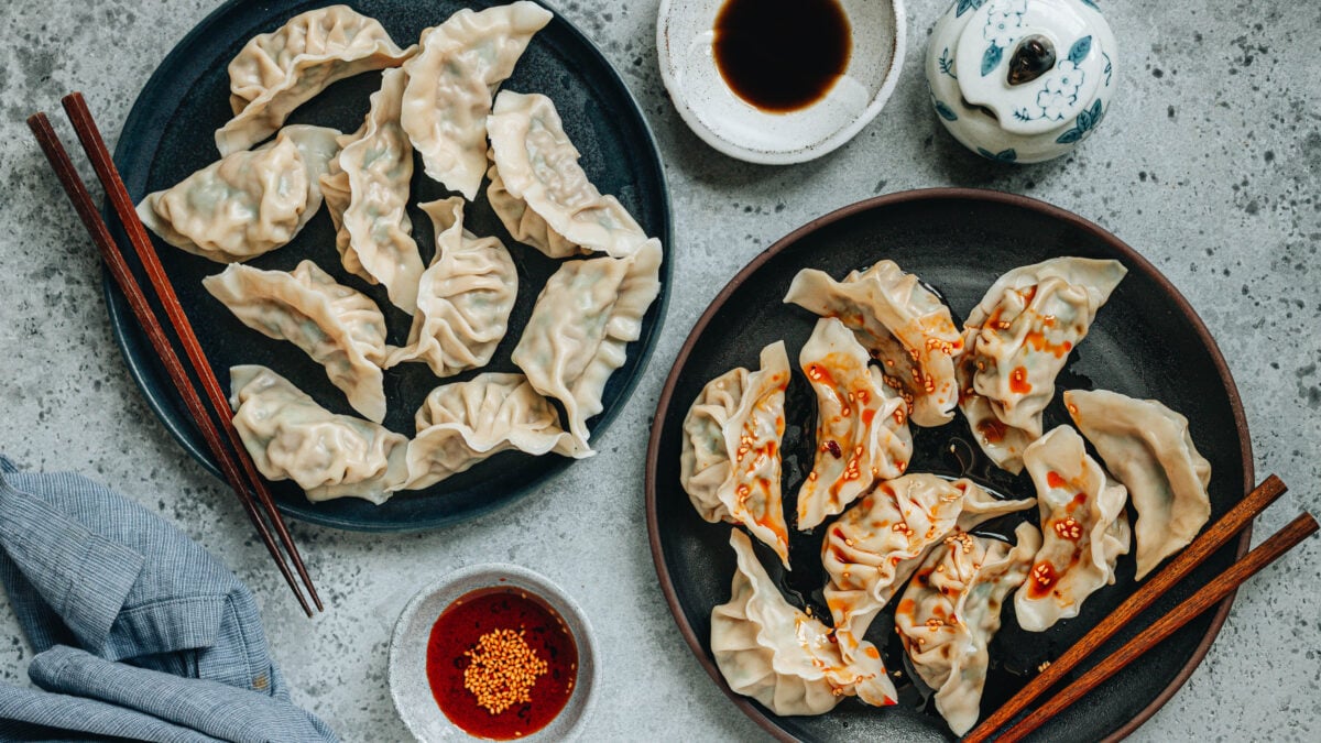 Pork and Chive Dumplings on plates and sauces