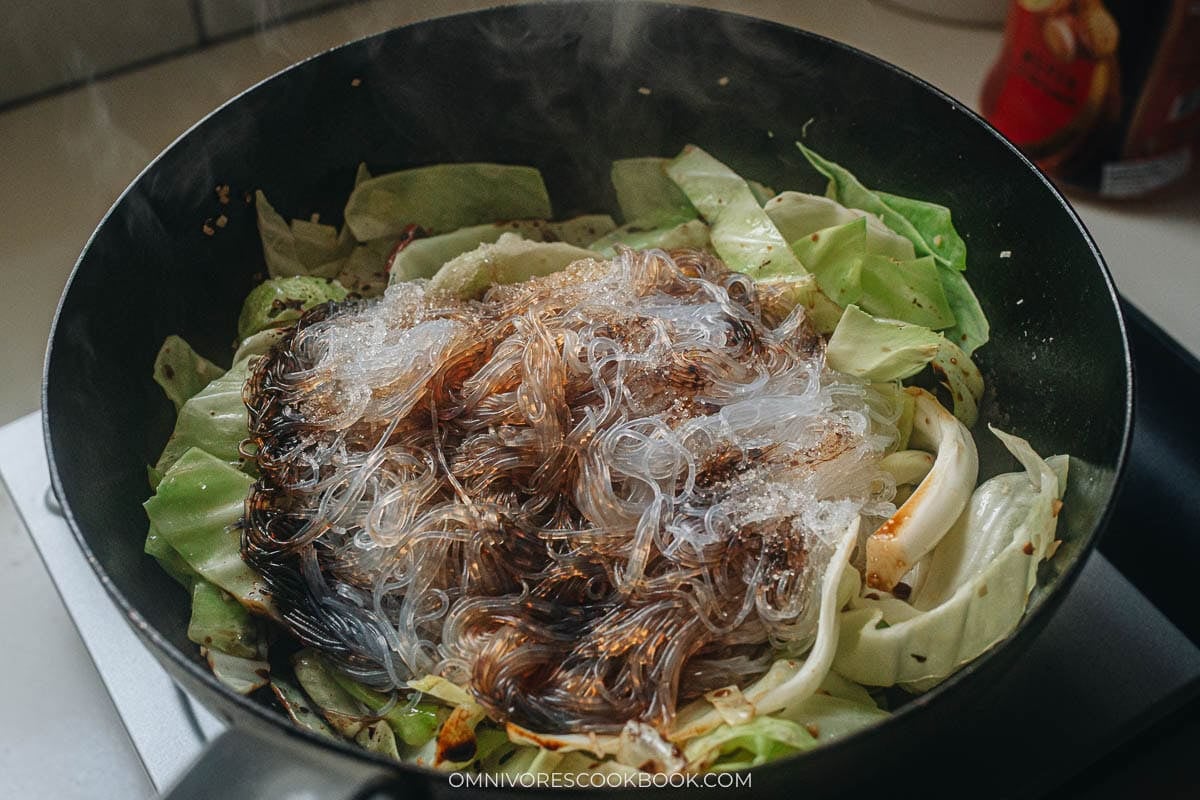 adding the noodles with the cabbage