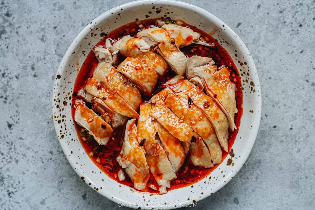 sliced chicken mixing with the sauce