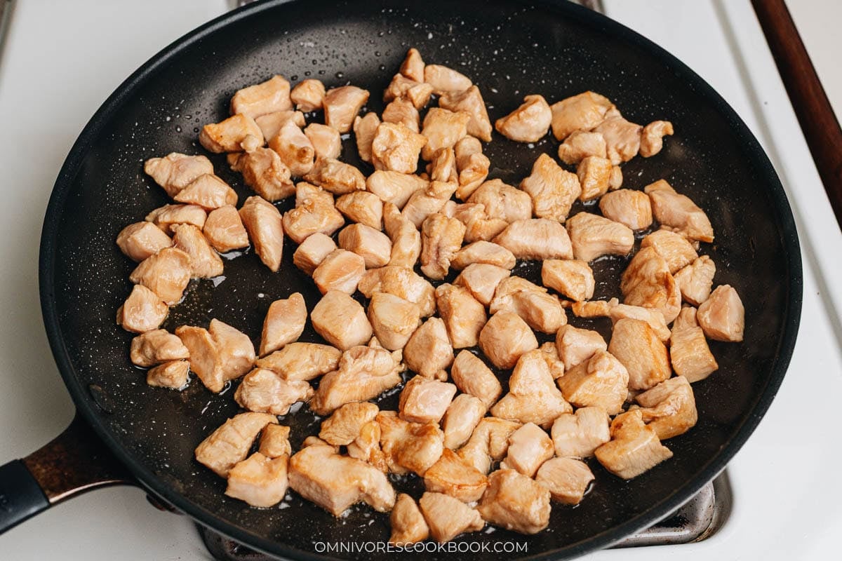 Searing the chicken in a pan