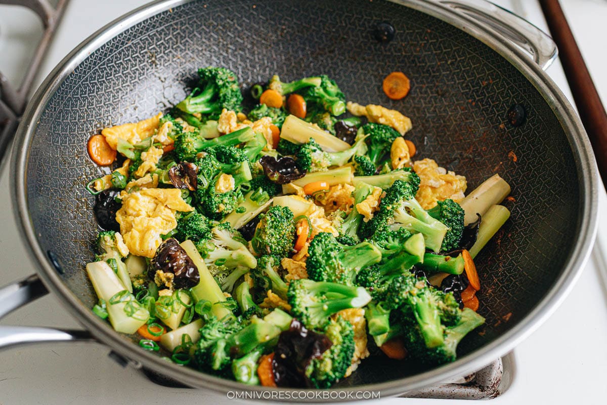 Broccoli and egg stir fry in wok with brown sauce