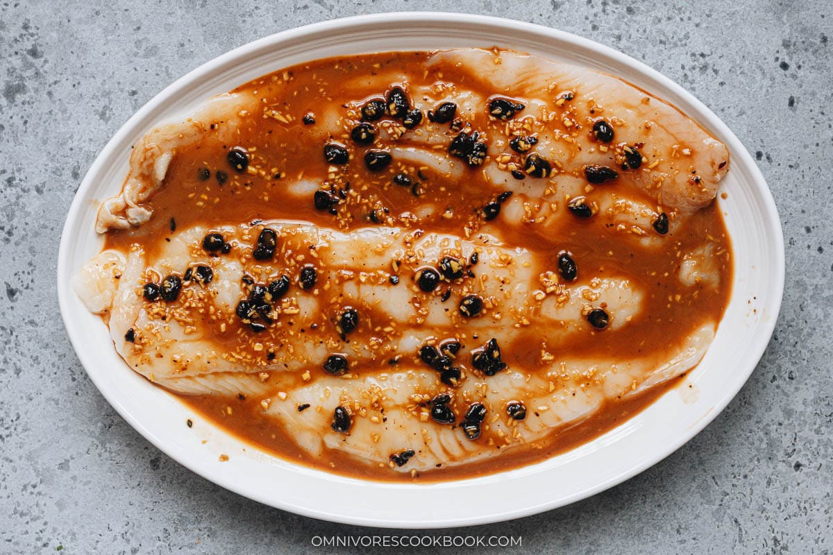 fish fillets on a plate with black bean sauce