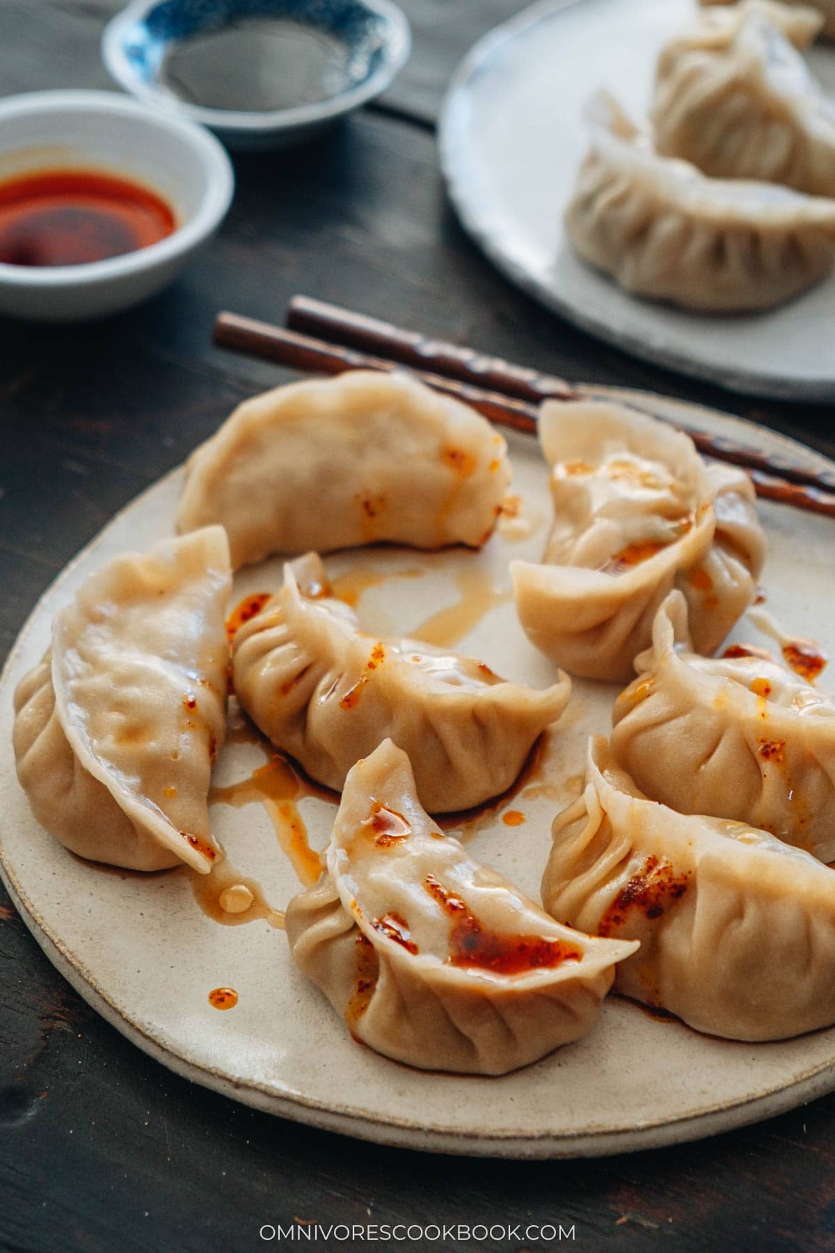 pork dumplings on a plate with chili oil