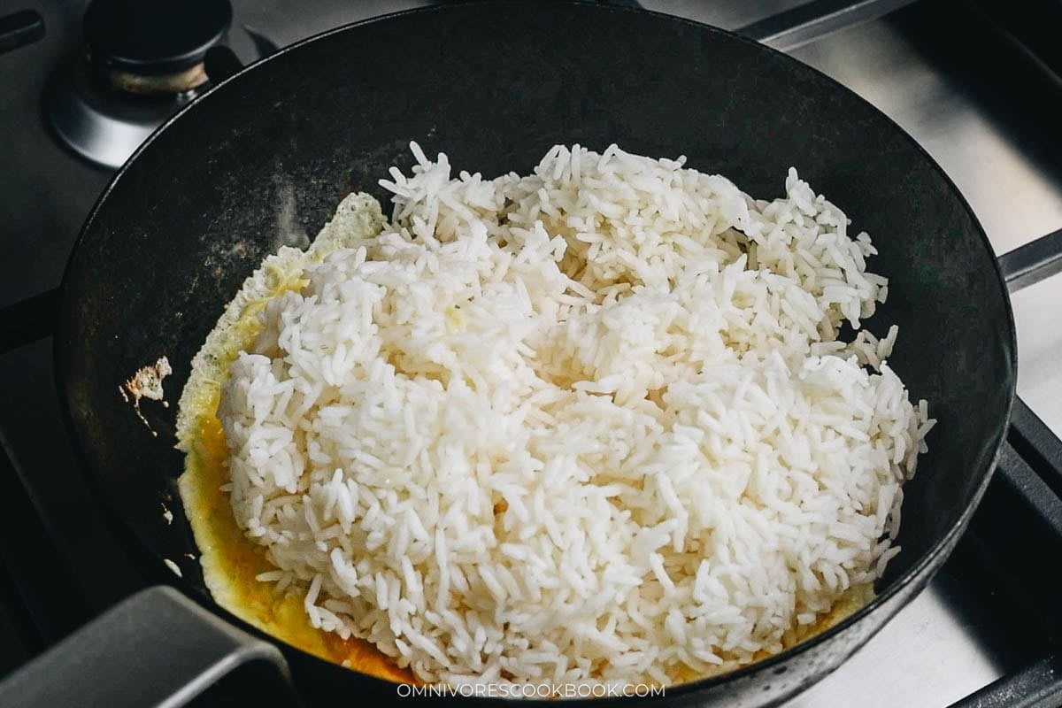 White rice on top of scrambled eggs