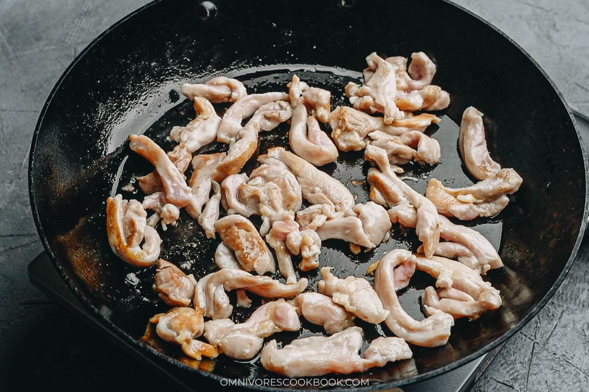 cooking the chicken in a pan