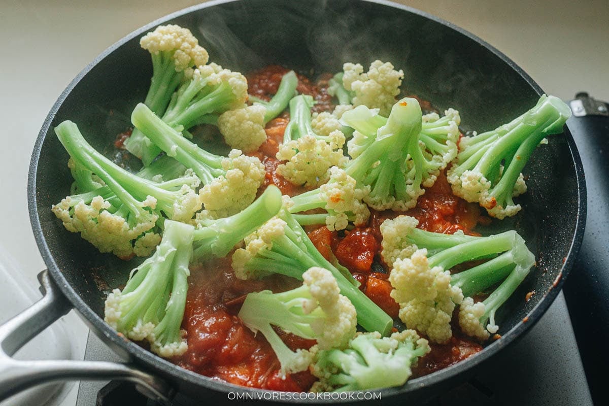 adding the cauliflower to the tomato base