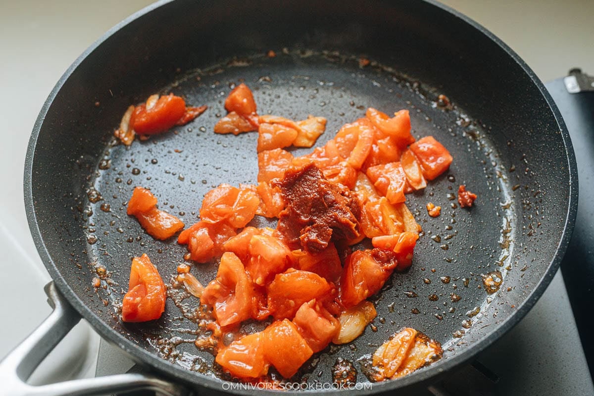diced fresh tomato cooking in a pan