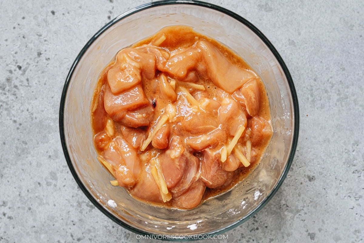marinating the chicken in a bowl