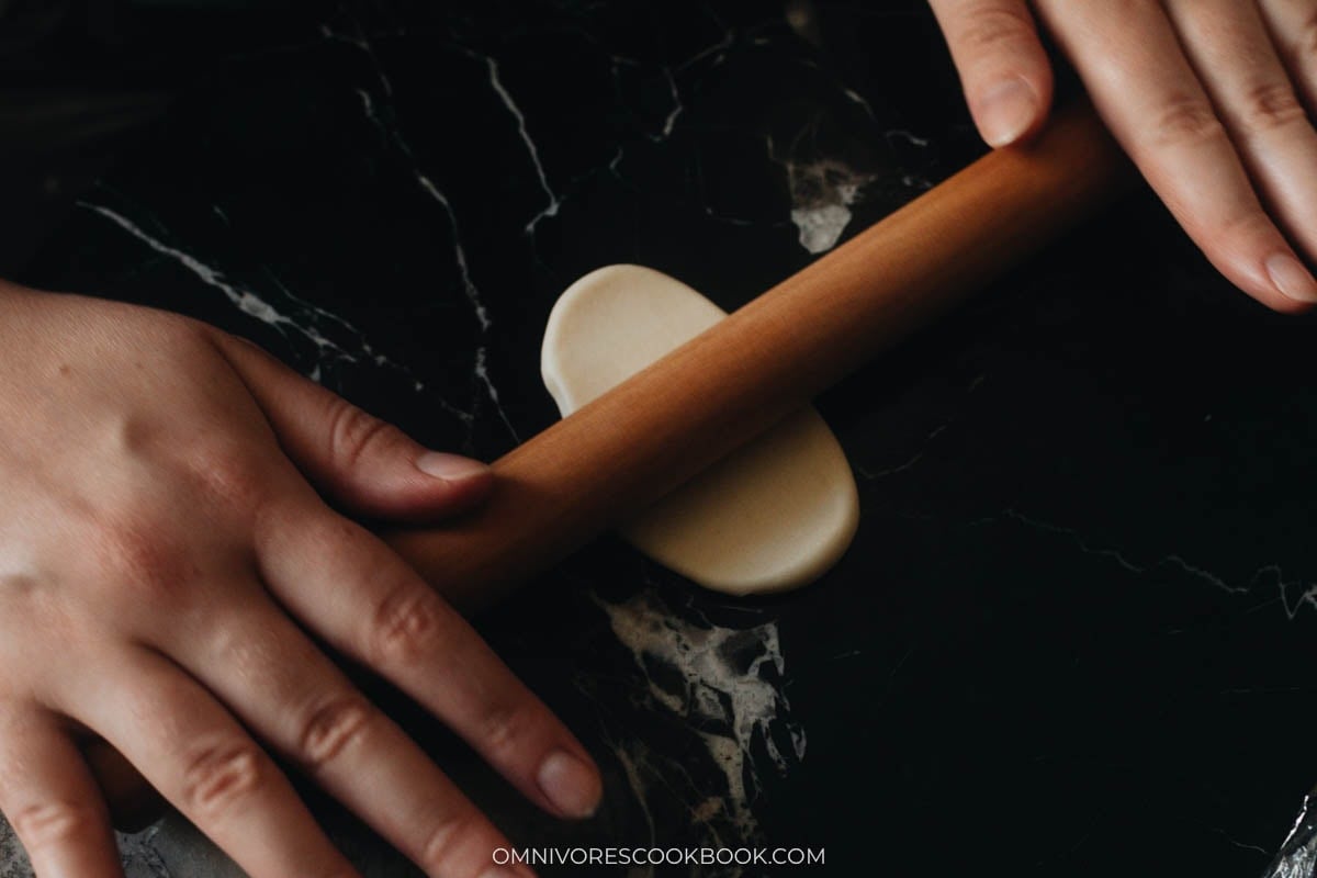 Rolling dough into a thin oval