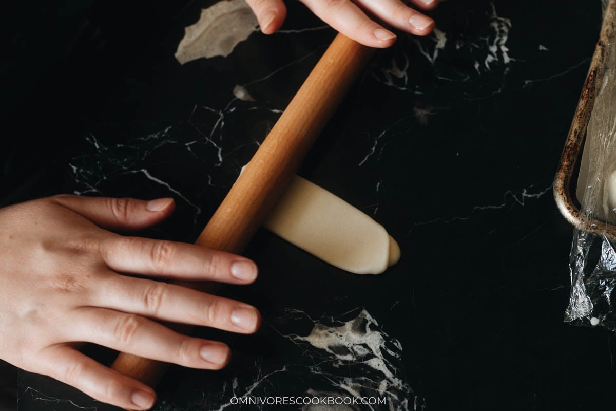 Flattening pastry dough with rolling pin