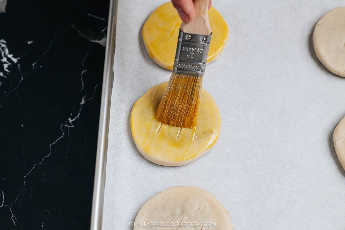 Brushing egg wash onto wife&rsquo;s cake before baking