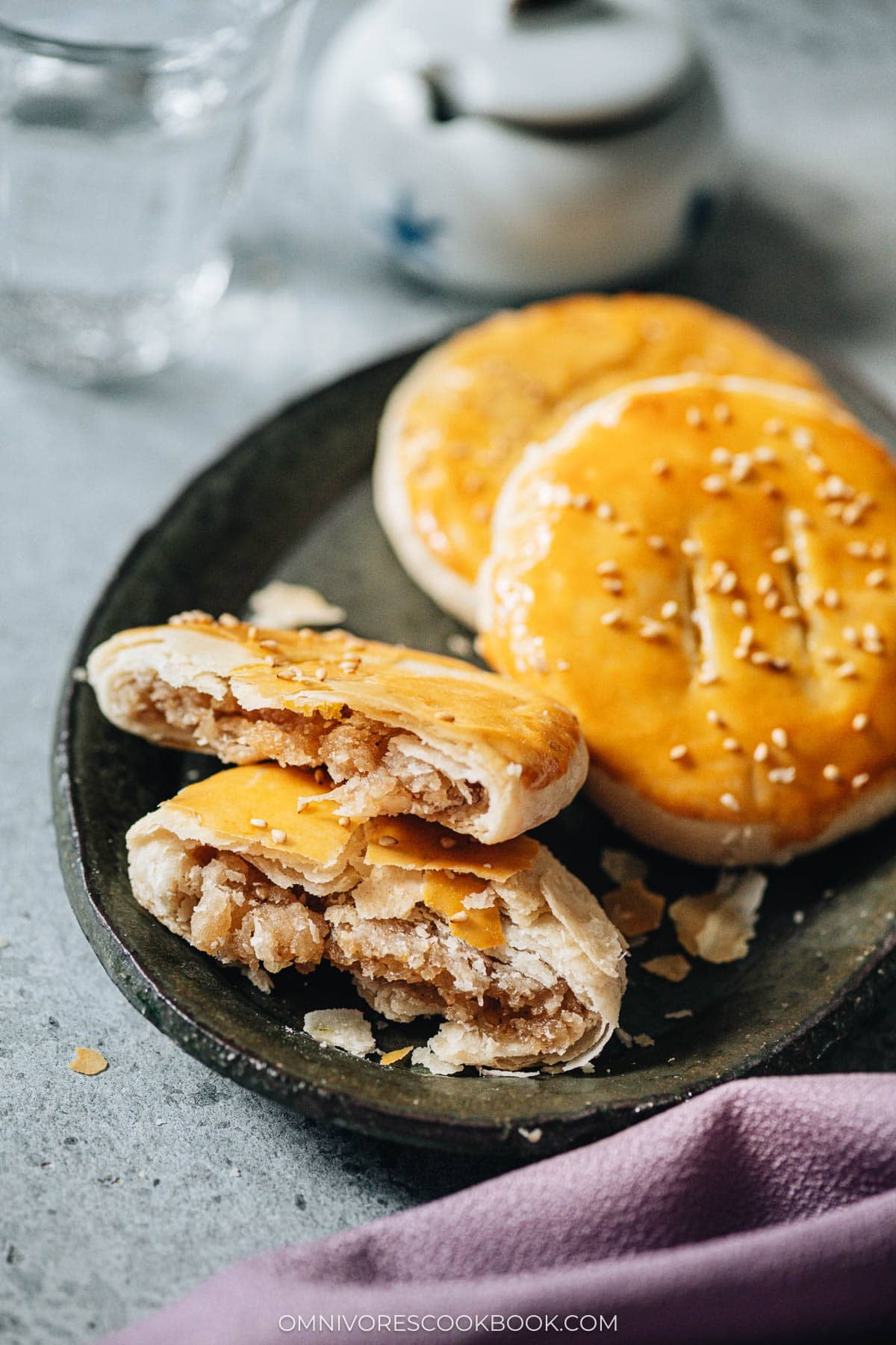 Stack of Lao Po Bing served on a dark plate