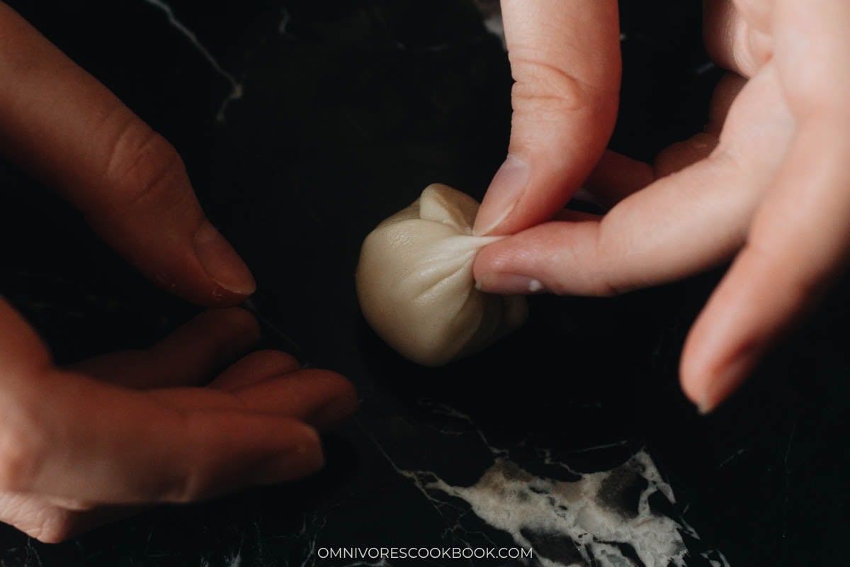 Pinching dough closed to seal the pastry dough