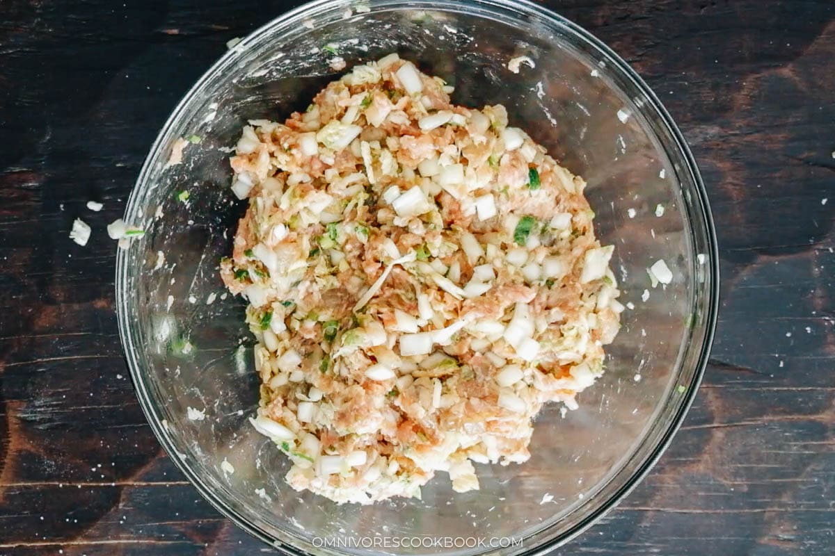 mixing pork filling in a bowl