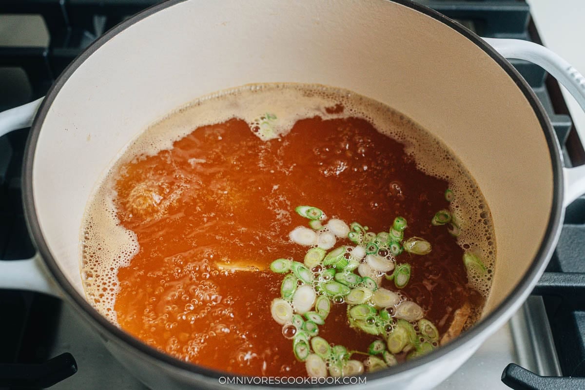 Simmering the broth with aromatics