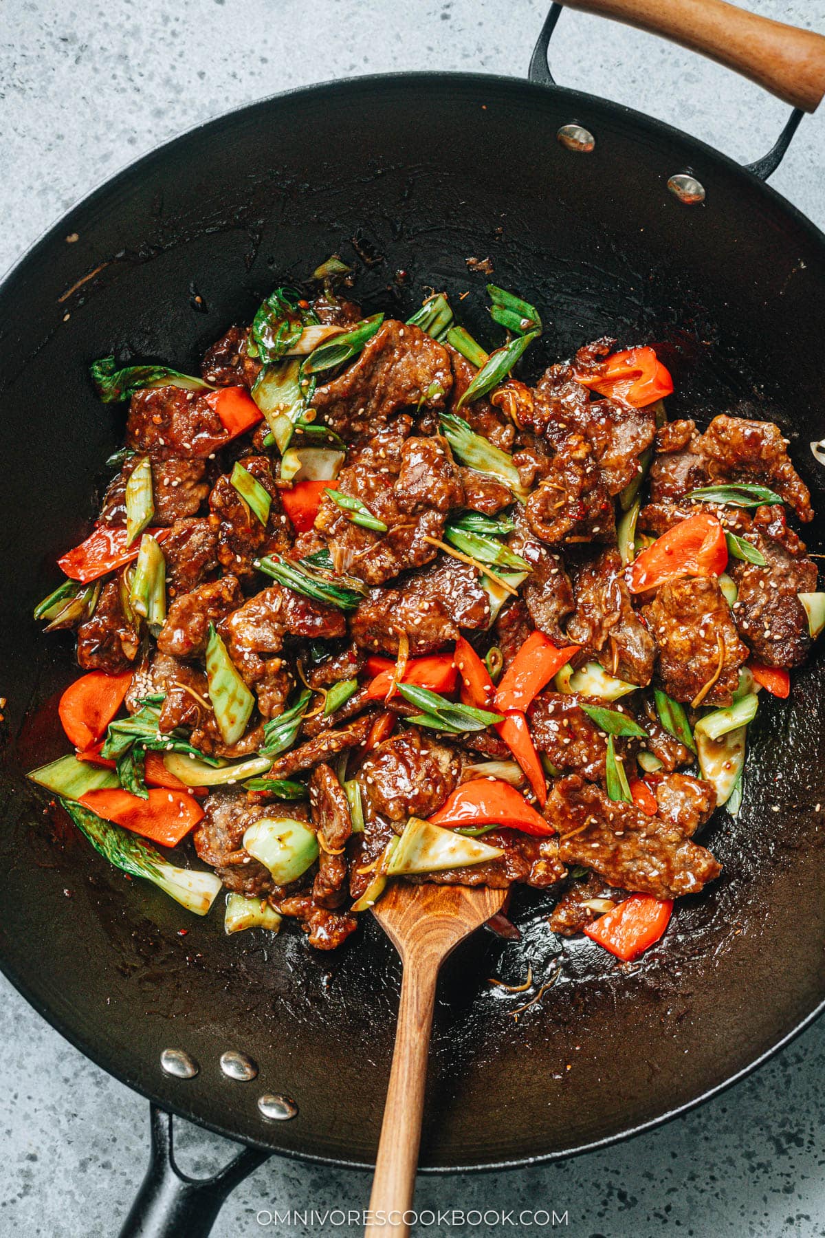 Ginger Beef | Crispy juicy beef, crunchy bell peppers, and tender baby bok choy are tossed in a rich sauce that is sweet, spicy, sour, and peppery. Pair this ginger beef stir fry with a bowl of rice to soak up the deep, arresting flavors of the sauce, and you’ll have a princely takeout favorite with ten times the taste! {Gluten-free adaptable} Ginger beef with bok choy and peppers