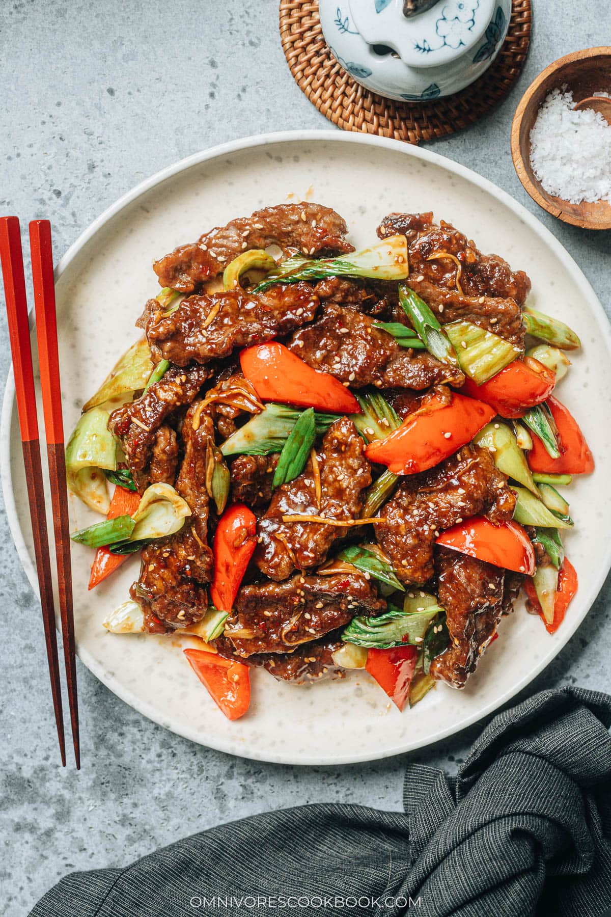 Ginger Beef | Crispy juicy beef, crunchy bell peppers, and tender baby bok choy are tossed in a rich sauce that is sweet, spicy, sour, and peppery. Pair this ginger beef stir fry with a bowl of rice to soak up the deep, arresting flavors of the sauce, and you’ll have a princely takeout favorite with ten times the taste! {Gluten-free adaptable} Ginger beef stir fry in a pan