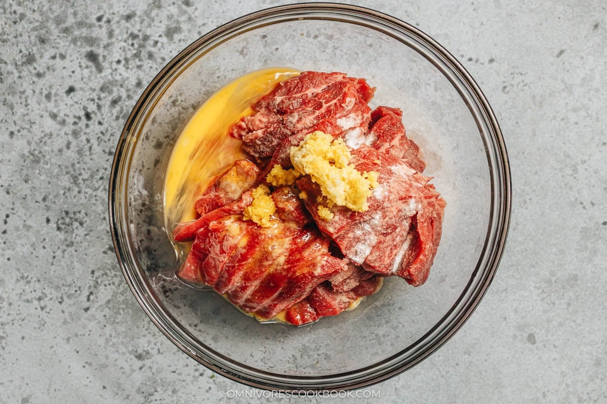marinating the beef in a bowl