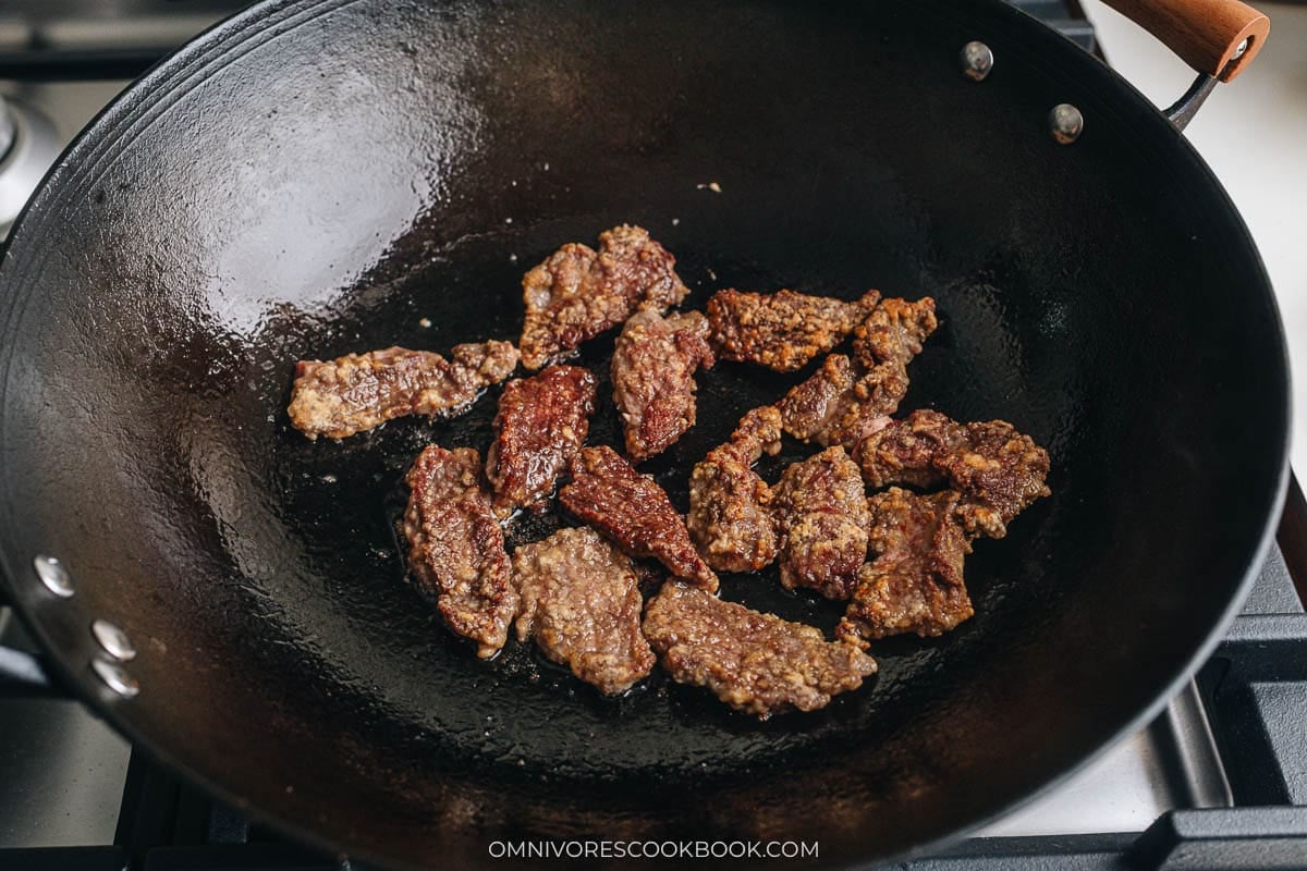 cooking the beef in a pan