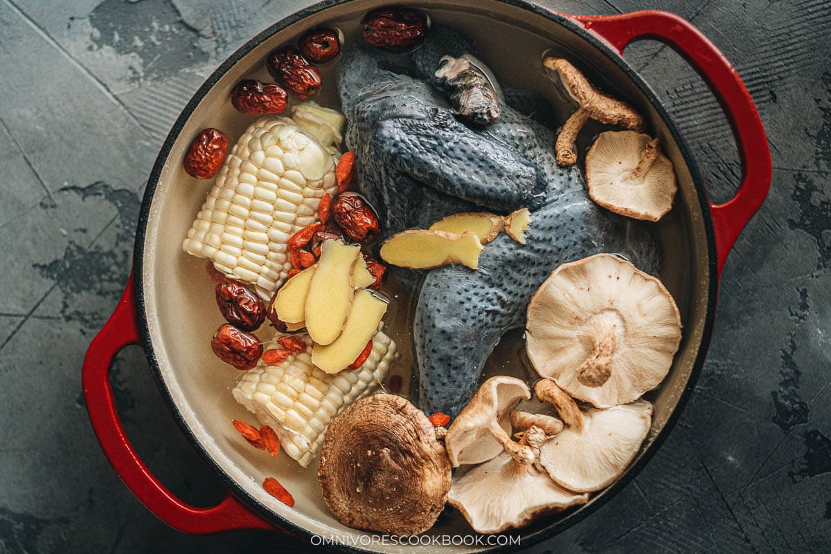 Silkie Chicken Soup - A healthy, nutrient-rich savory soup with a touch of sweetness ideal for cooler weather or when you’re under the weather! #chinese #recipe #healthy Chinese silkie chicken soup ingredients in a dutch oven