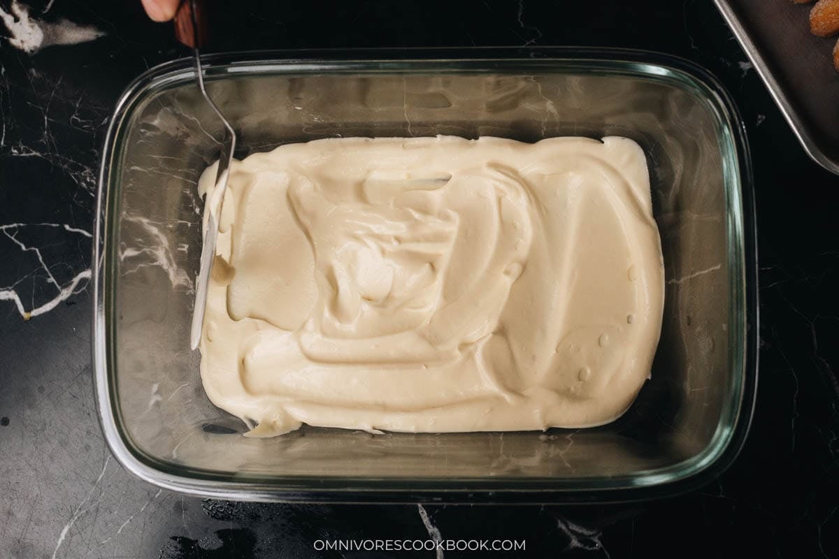 layering the cream on a baking dish