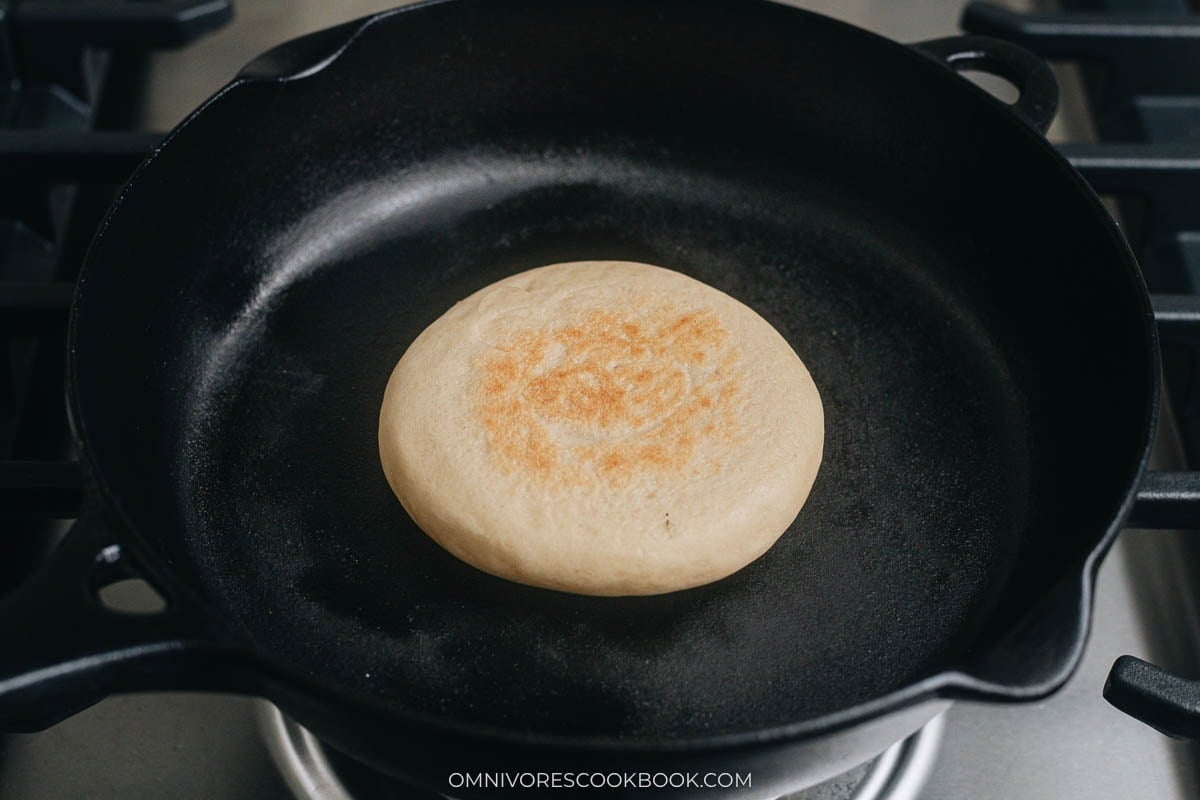 cooking the flatbread on a skillet