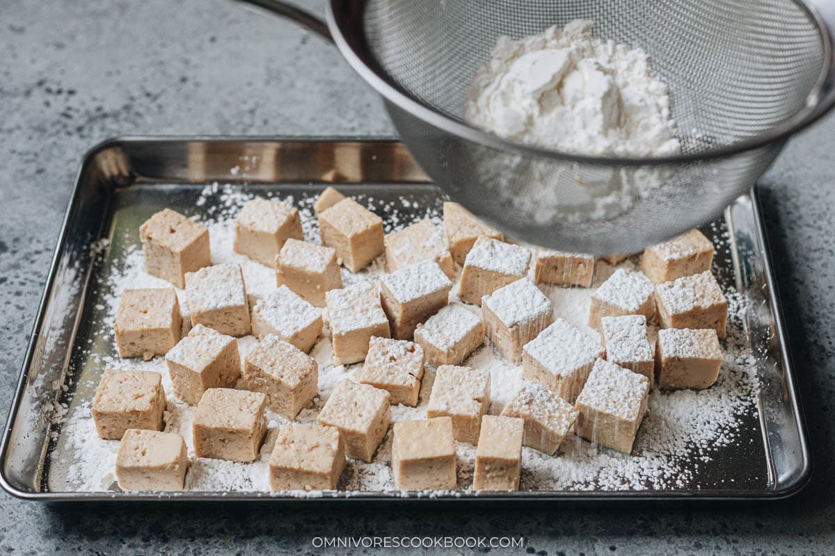 Dusting the tofu with cornstarch