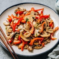 My mushroom and pepper stir fry is a 15-minute side dish that uses minimal ingredients to create a satisfying dish. The tender mushrooms and crisp peppers are coated with a rich garlicky brown sauce that brings everything together without overpowering the fresh flavors.