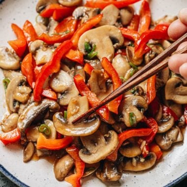 Use chopsticks to lift mushroom and pepper from a plate