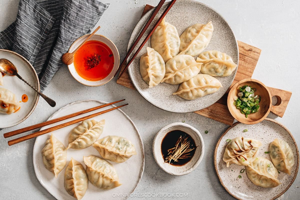 two plates served with nepalese dumplings and sauces on the side