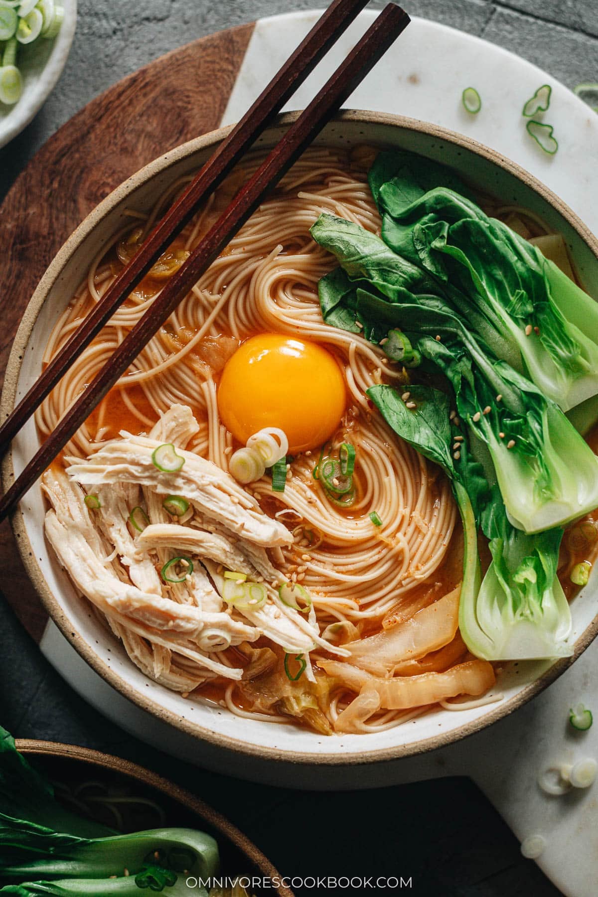 Korean noodle soup with chicken, egg and baby bok choy