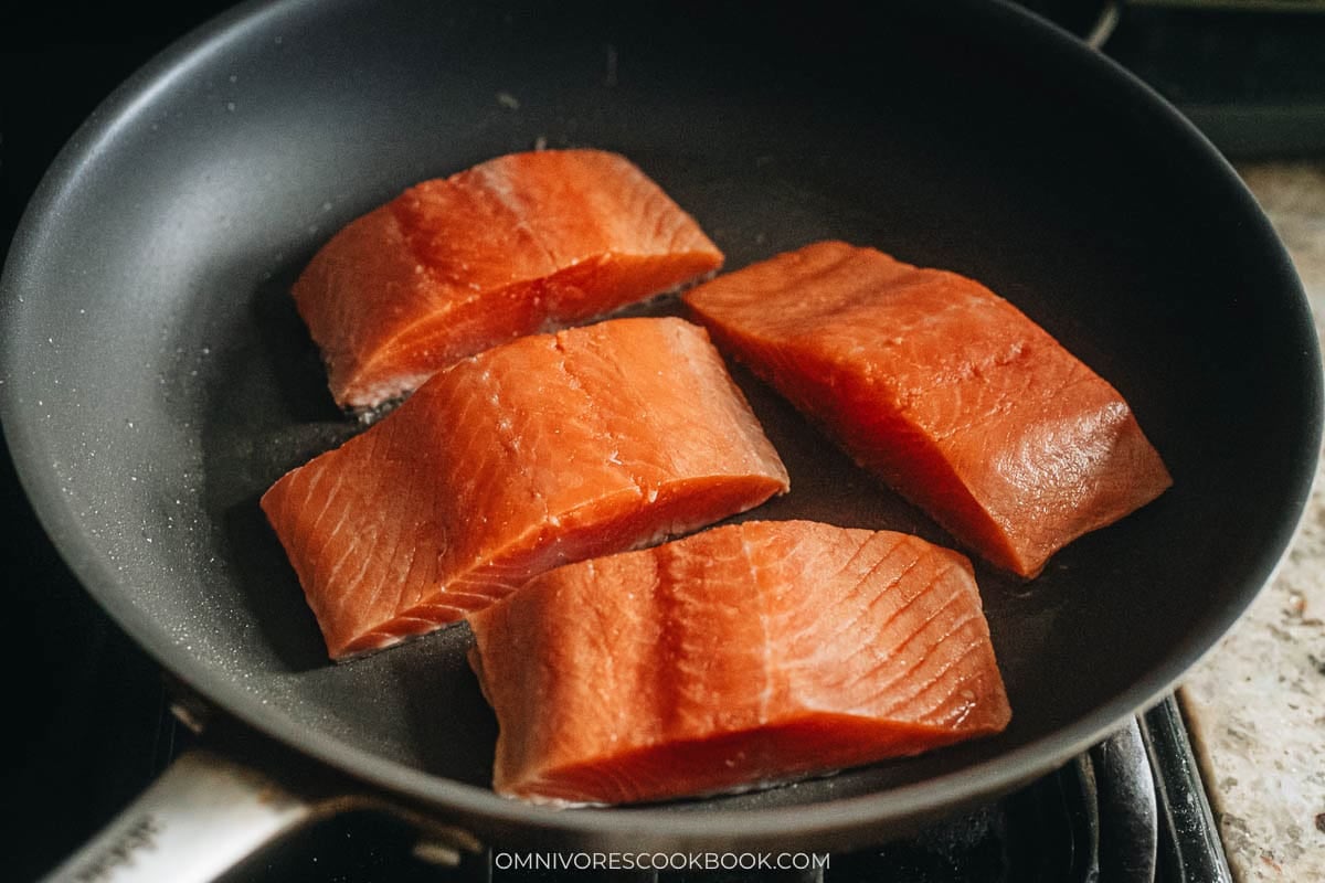 searing the salmon skin in a skillet