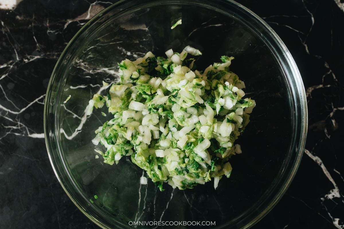 Salting the napa cabbage in a bowl