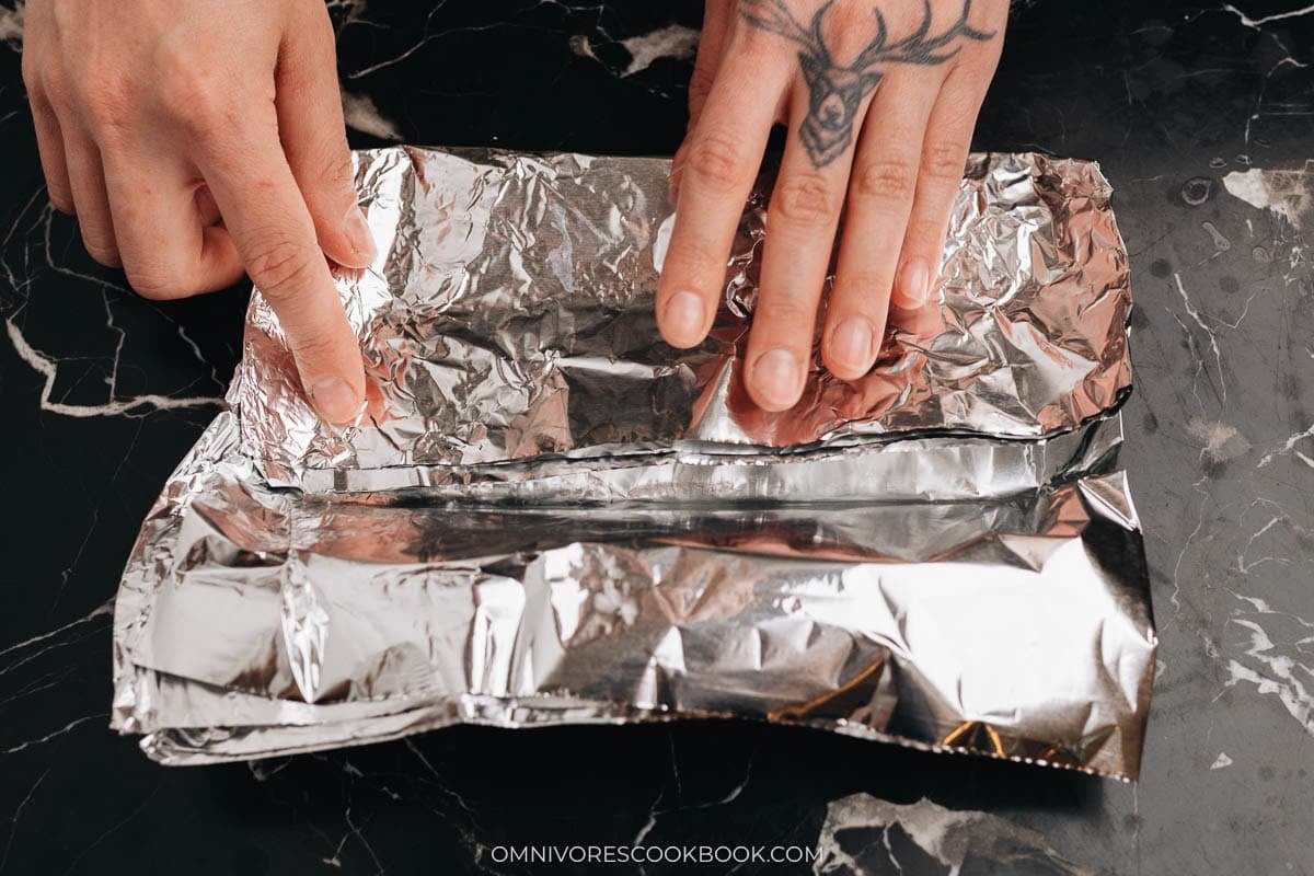 Fold the four edges of the foil pan