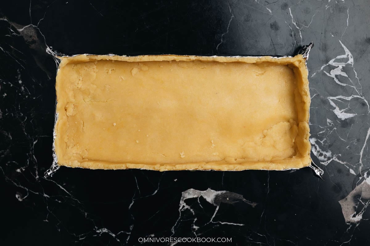 Transfer the dough into the pan and press well