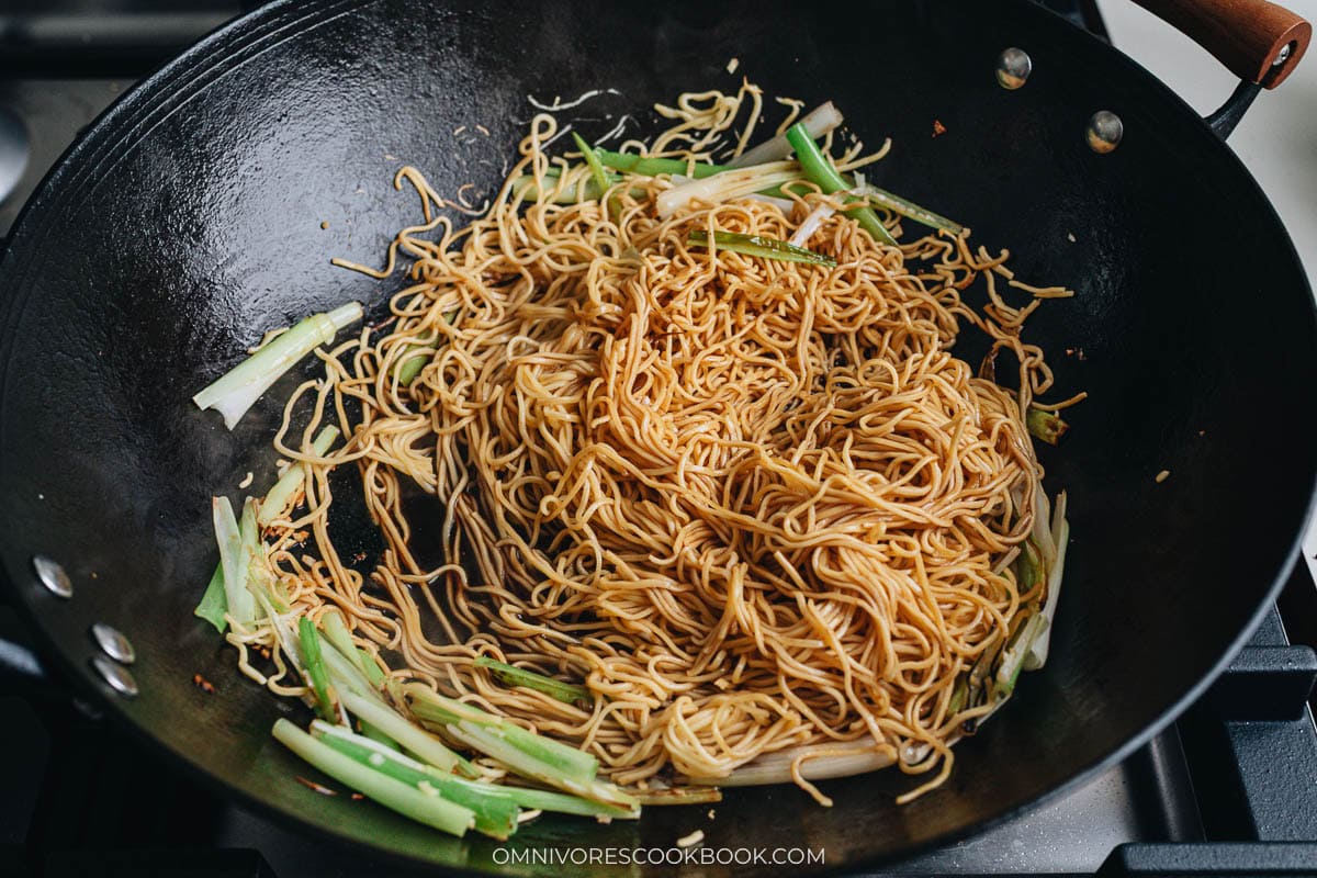 Tossing the noodles with onion