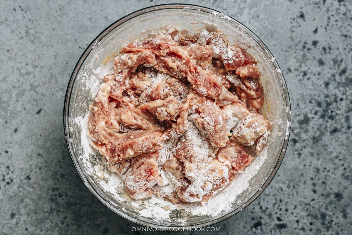 marinating the pork in a bowl